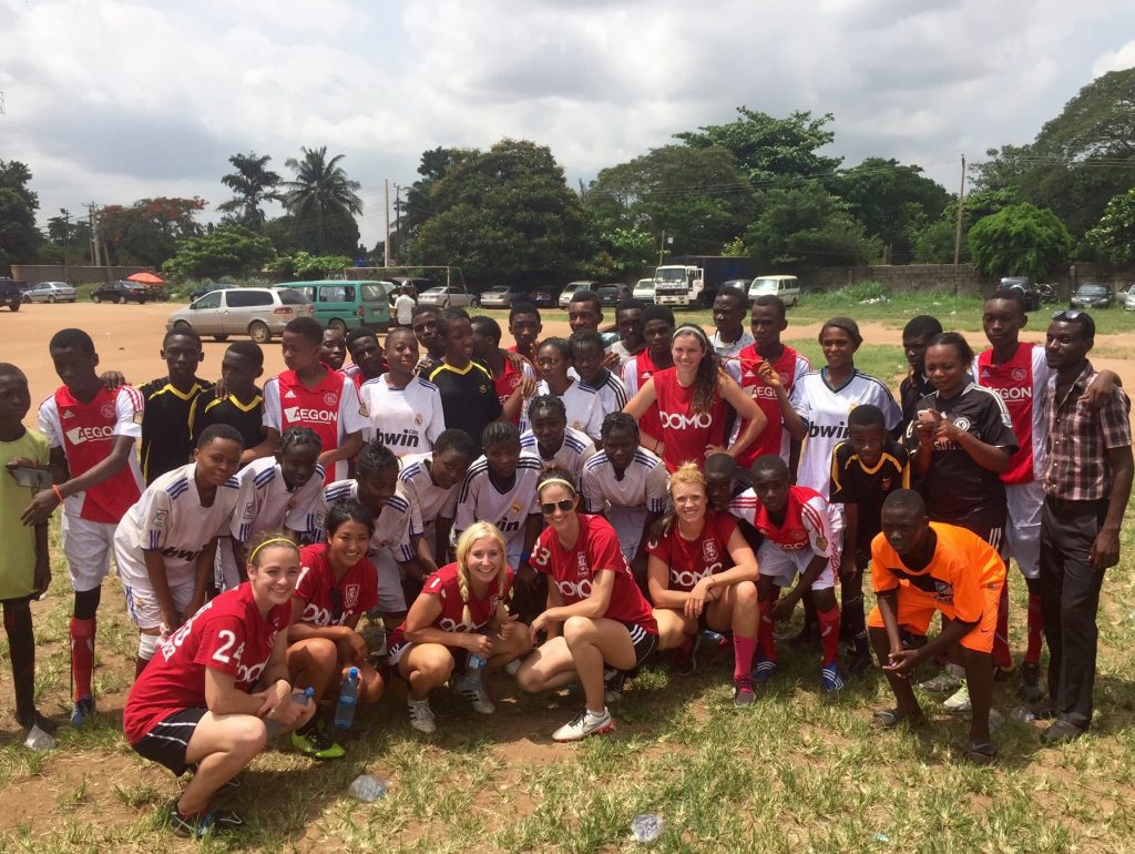 Members of the RSL Women's team posing for pictures or "snaps" with local girls soccer players ion Lagos, Nigeria after conducting a free soccer clinic.